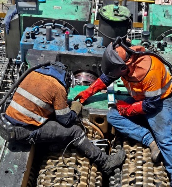 Two R8D tradespeople welding on fixed plant equipment